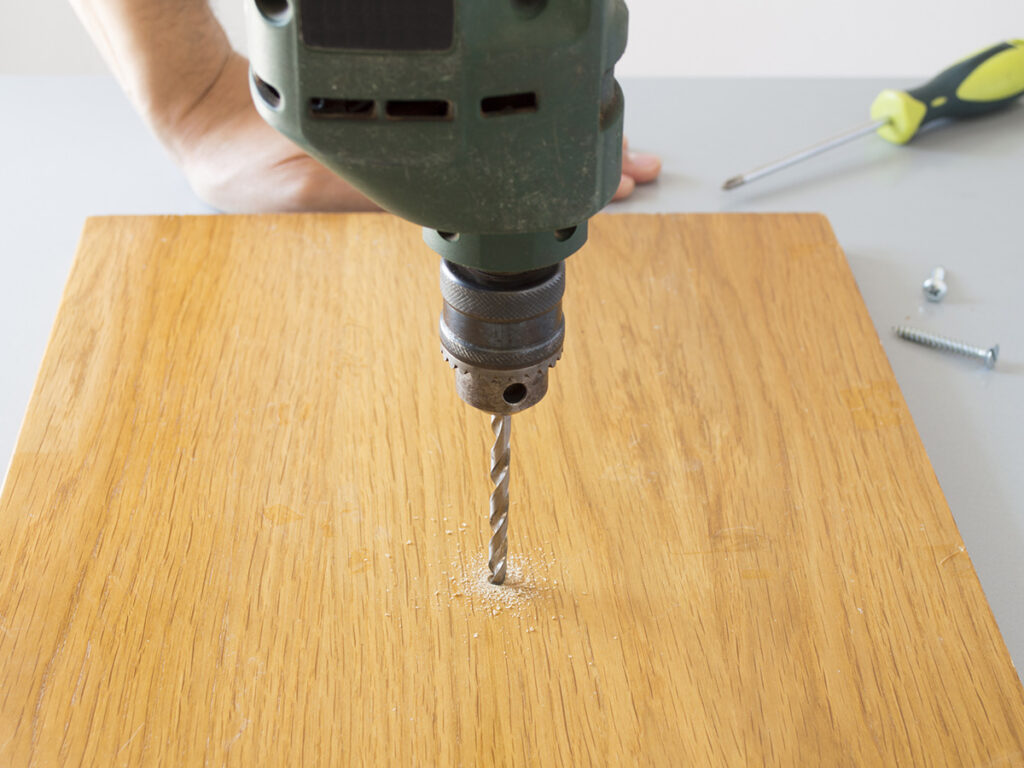 Person drilling a pilot hole.