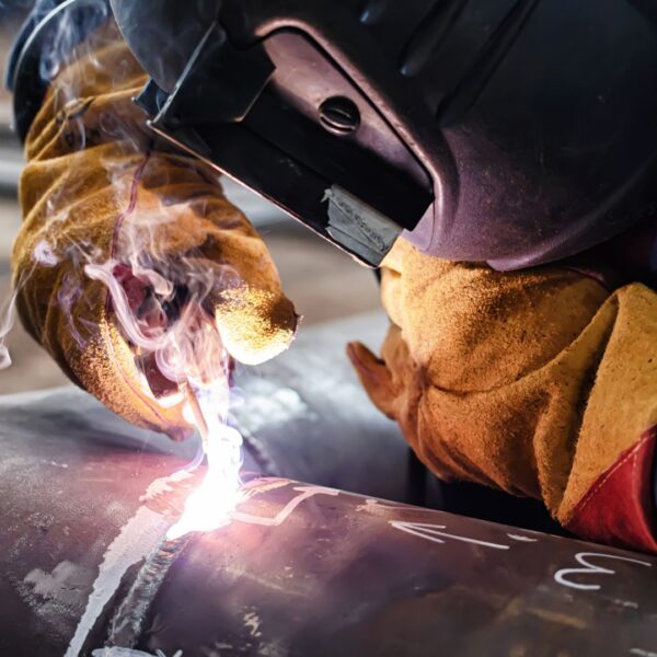 Person wearing gloves and welding
