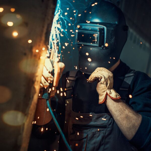 Male welding wearing welding mask