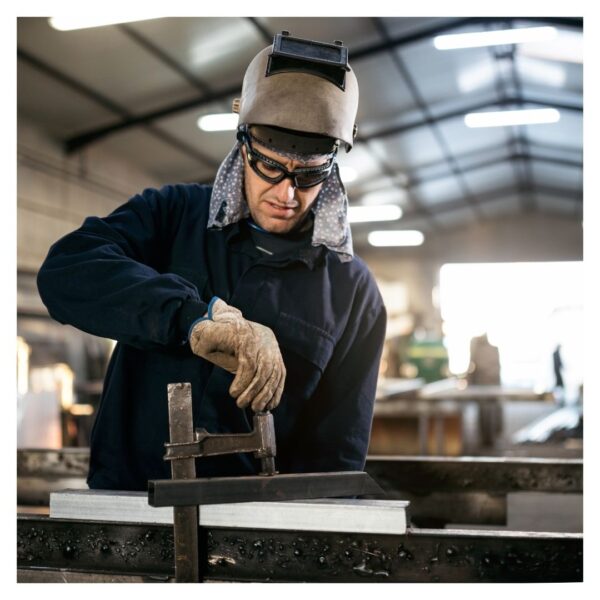 Welder with helmet lifted up