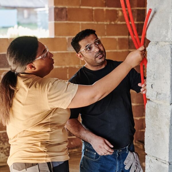 tradespeople wearing safety glasses on construction site