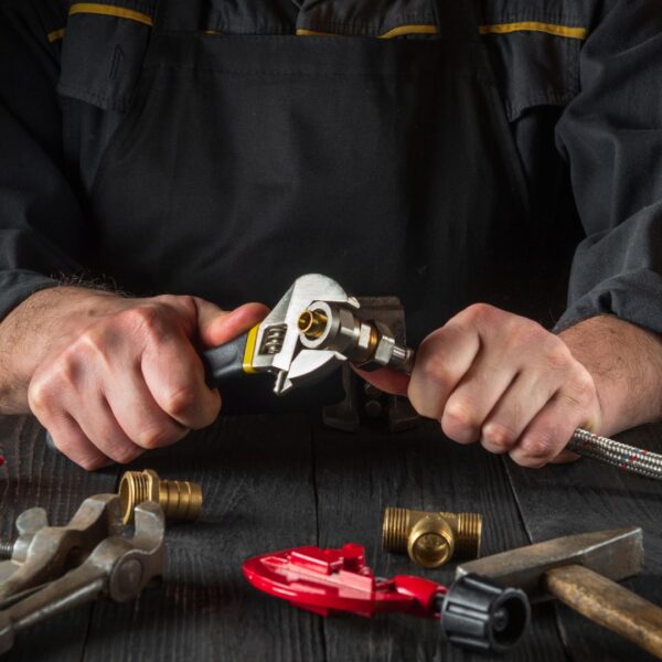 An adjustable wrench tightening a bolt.